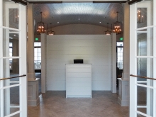 Union League Golf Club renovation- entryway with paneled glass doors, gray diagonal tiled floor and reception area