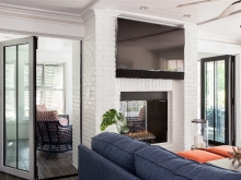 double fireplace and window walls that open on to porches