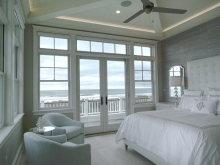 master bedroom with ocean views and indirect lighting in detailed ceiling