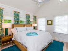 bright and colorful vaulted ceiling bedroom with fan