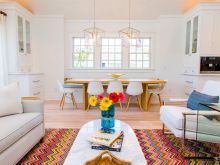 pops of bold color enliven this white wood detailed living area