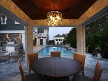 outdoor dining pergola adjacent to pool avalon nj dusk elegant lighting