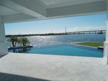 Infinity pool corner takes advantage of sweeping bay views, with shaded porch