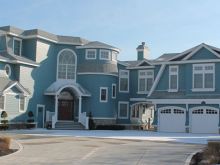 Gabled three car garage and classic details add elegance to this large bayfront home in southern NJ