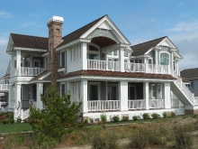 Large beachfront home Stone HArbor NJ with porches, covered, brick chimney, pool and poolhouse