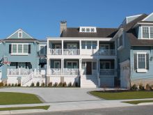 Grand bayfront classic styled custom home with garage, porches and stone foundation details