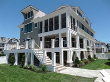 Classic Avalon NJ new custom home with three tiers of porches, bayfront beauty